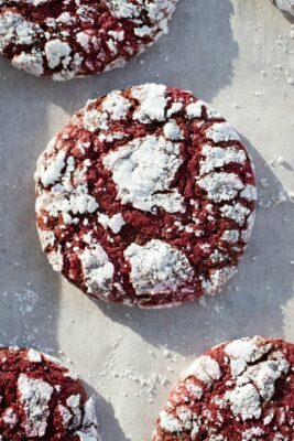 red velvet crinkle cookies on parchment paper