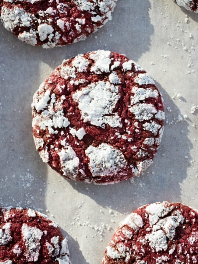 red velvet crinkle cookies on parchment paper