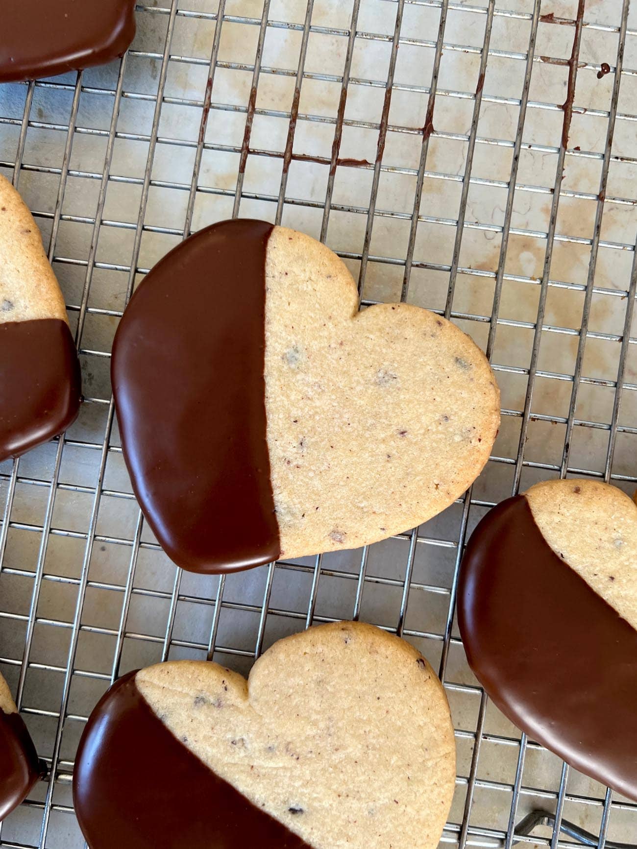 chocolate dipped cacao nib cut out hearts on wire rack