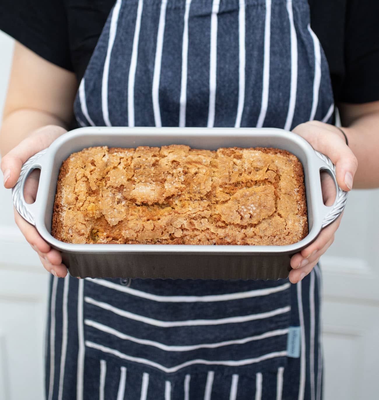 holding carrot bread in a pan