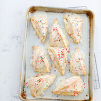 sprinkles cones with icing on baking tray