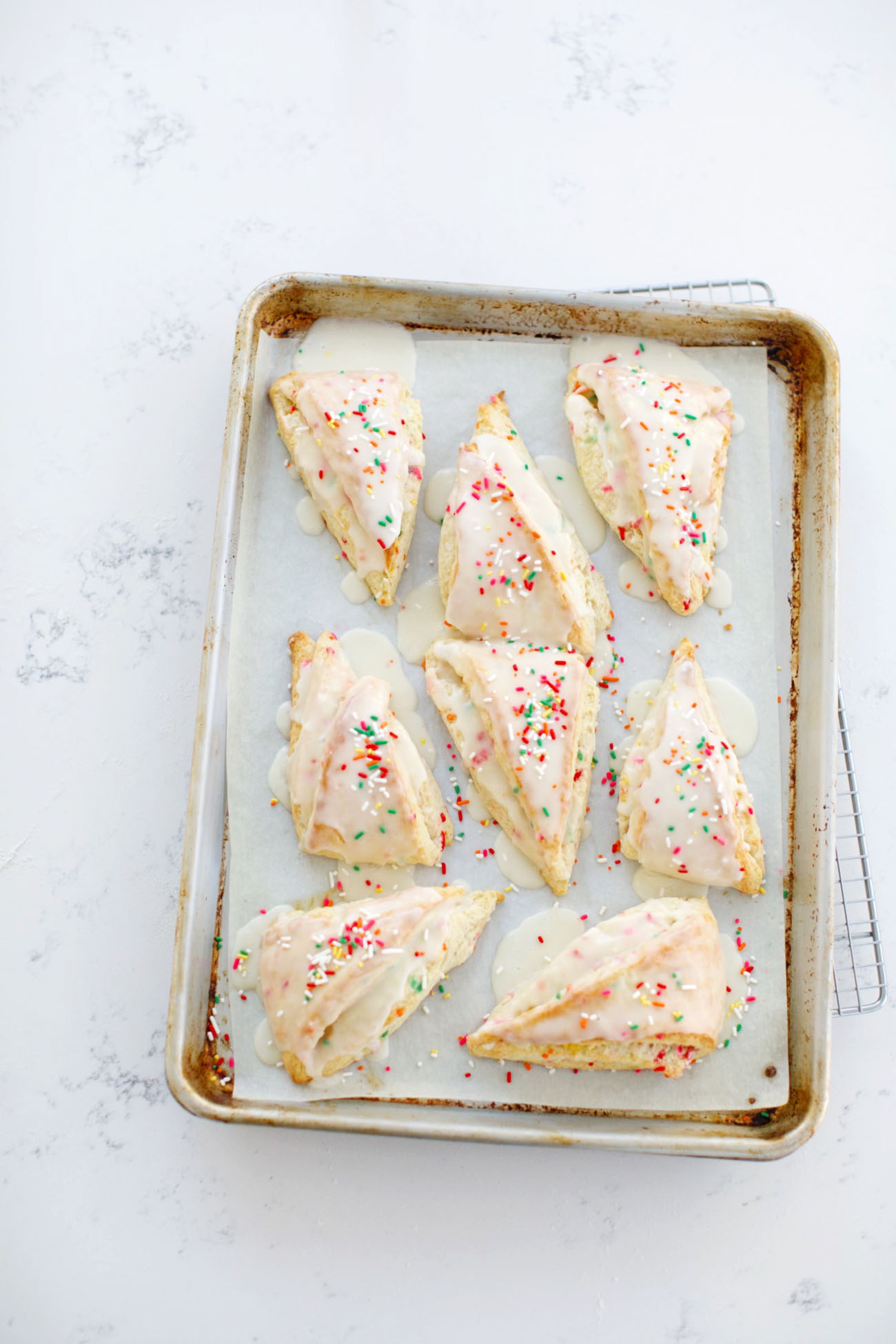 sprinkles cones with icing on baking tray