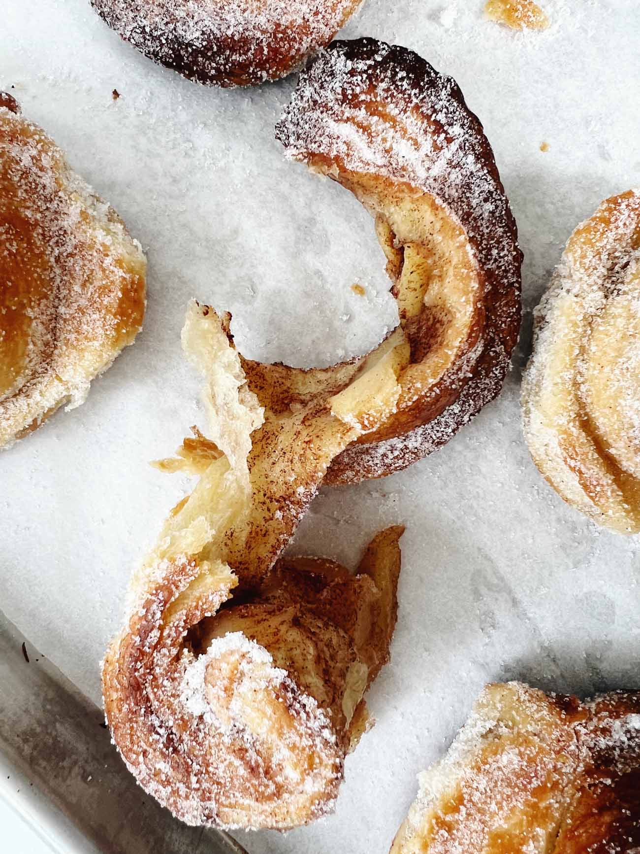 torn apple morning buns on parchment paper