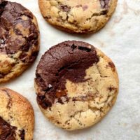 chocolate chocolate chip cookies on white parchment