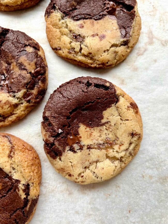 chocolate chocolate chip cookies on white parchment