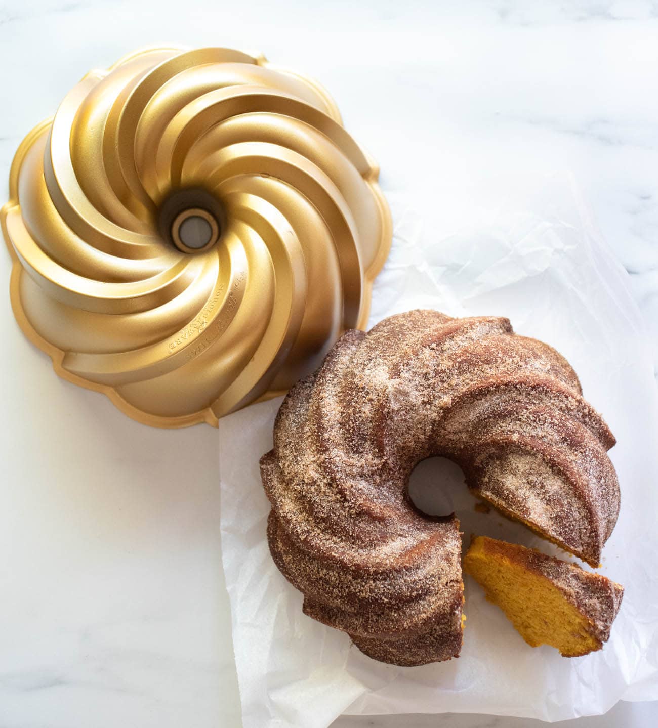 pumpkin bundt cake next to bundt pan