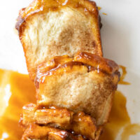 pull apart bread with caramel sauce on parchment paper