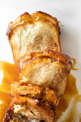 pull apart bread with caramel sauce on parchment paper