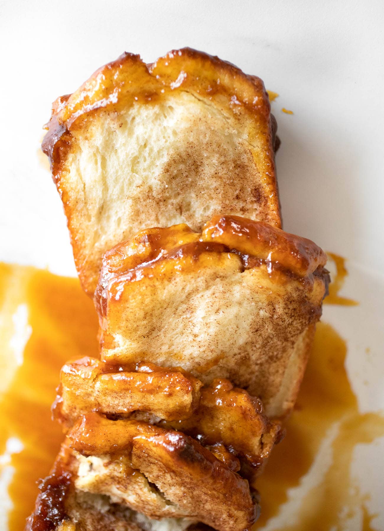 pull apart bread with caramel sauce on parchment paper