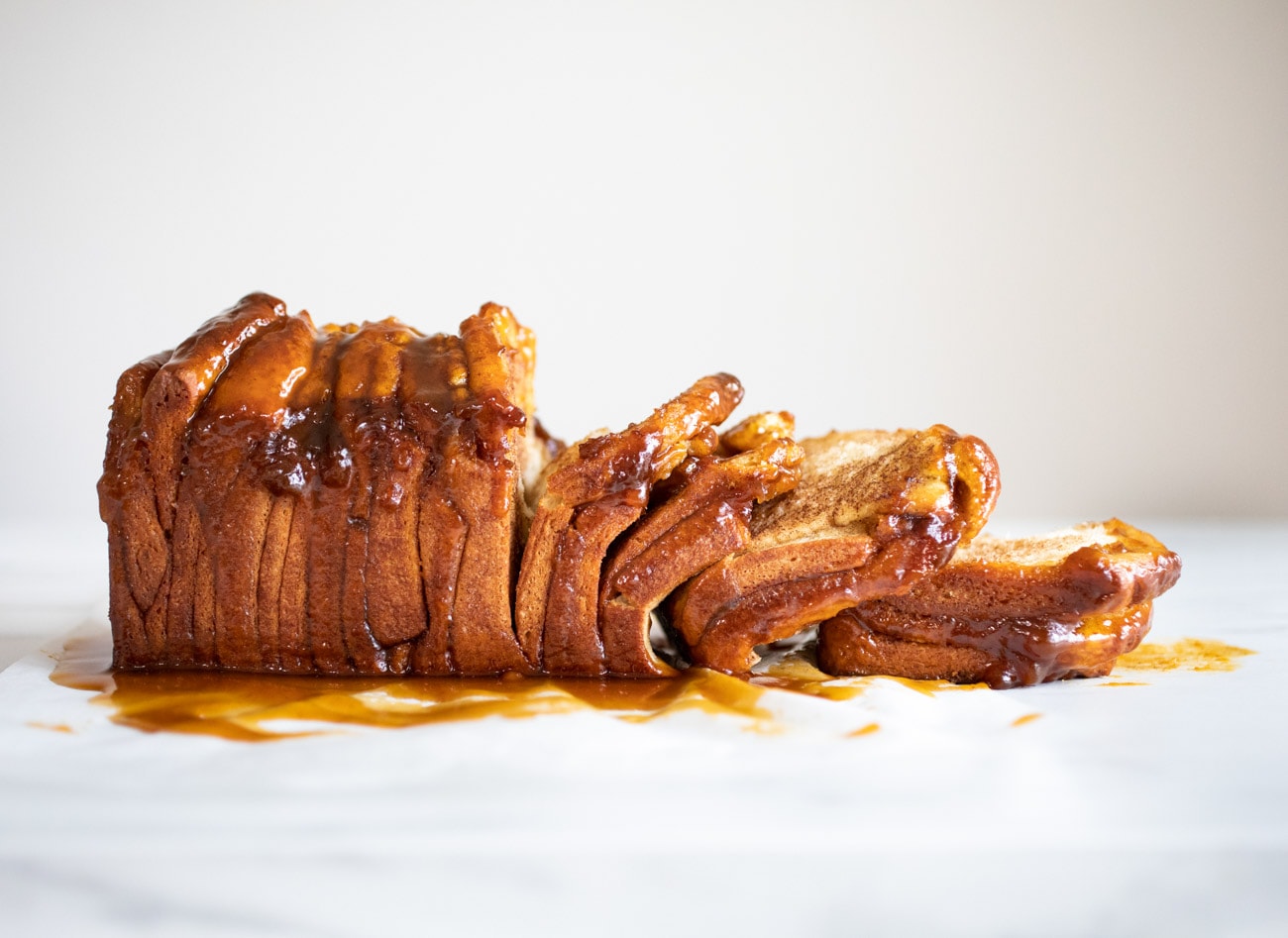 caramel pull apart bread on white parchment paper