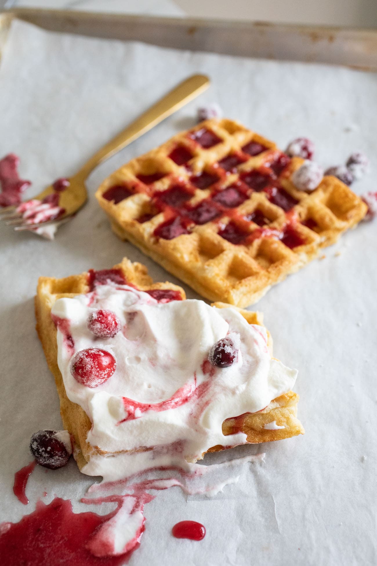 waffles with whipped cream and cranberry syrup