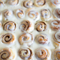 pan of mini cinnamon rolls with lots of icing