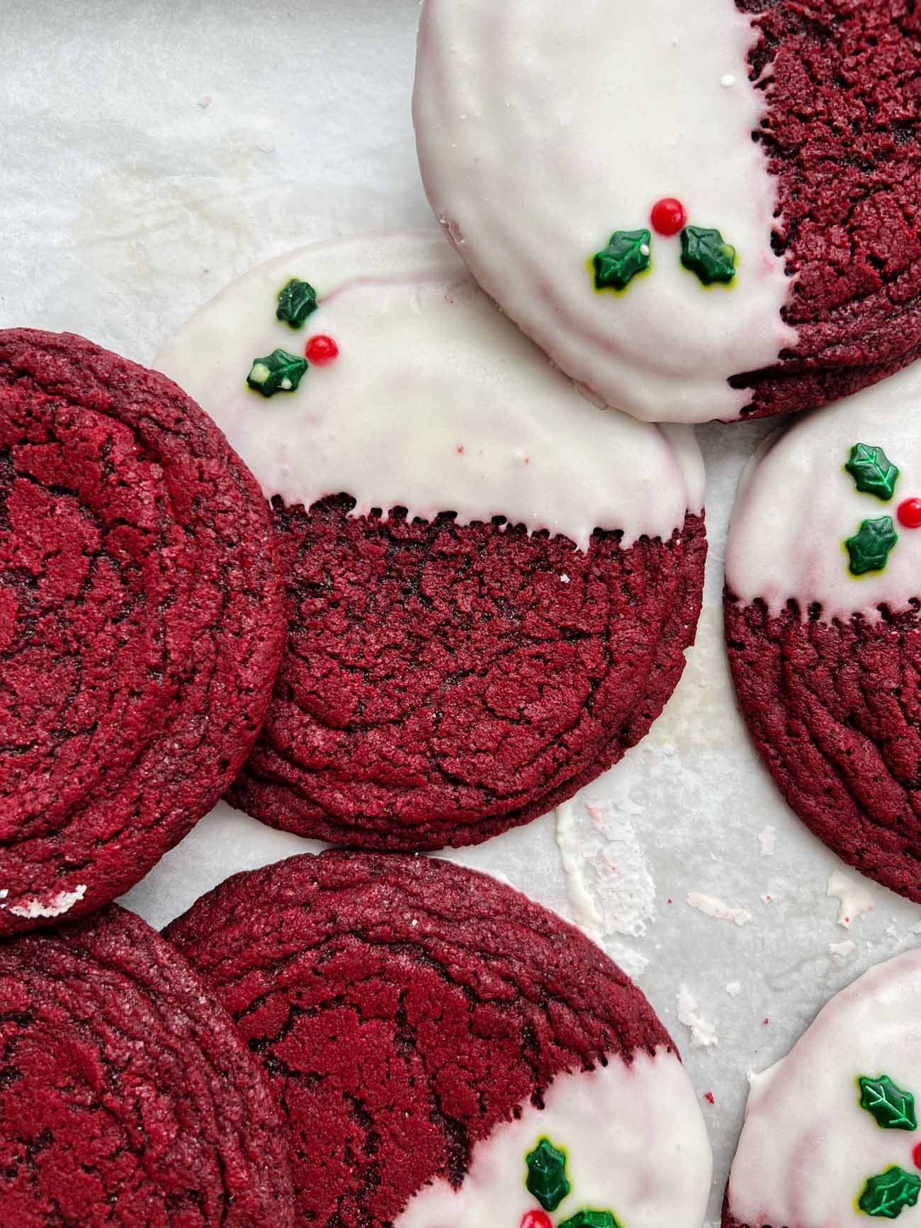 pan-banging red velvet cookies on white parchment paper