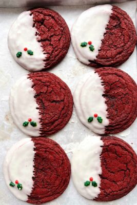 red velvet cookies with glaze on parchment paper