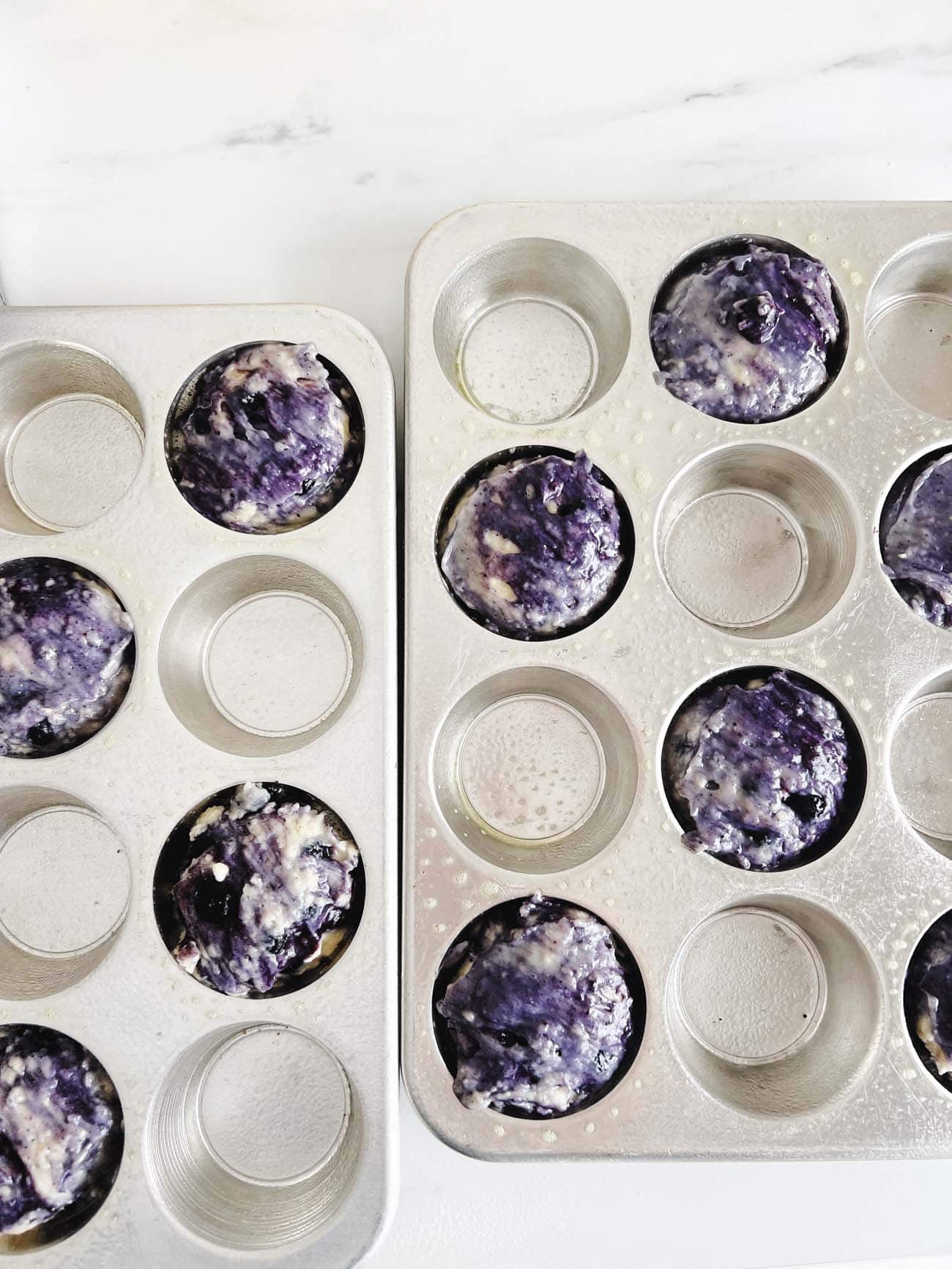 blueberry muffin batter in muffin tin 