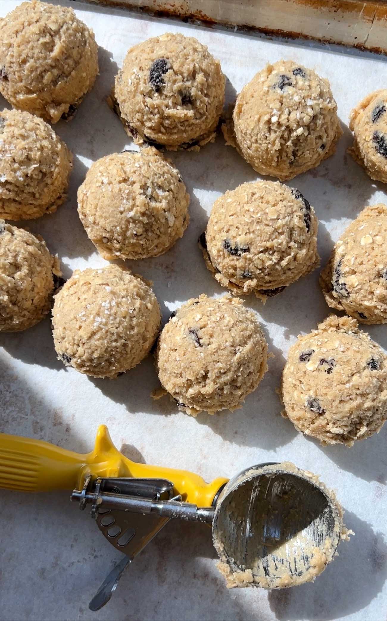 oatmeal raisin cookie dough with a yellow cookie scoop