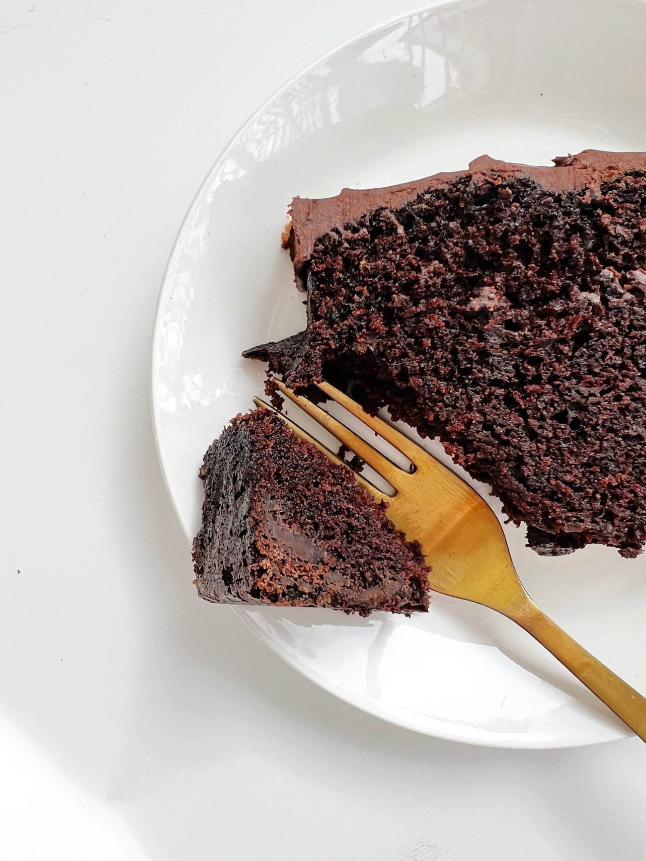 chocolate bread on white plate with gold fork