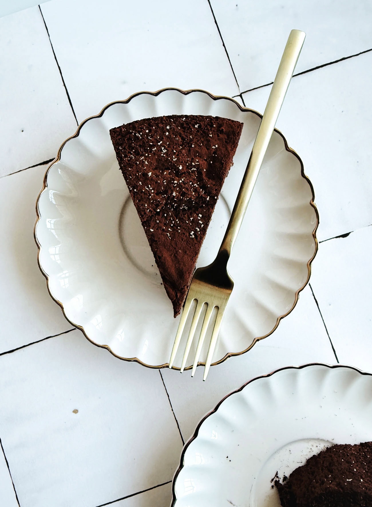 chocolate cake on white plate with gold fork