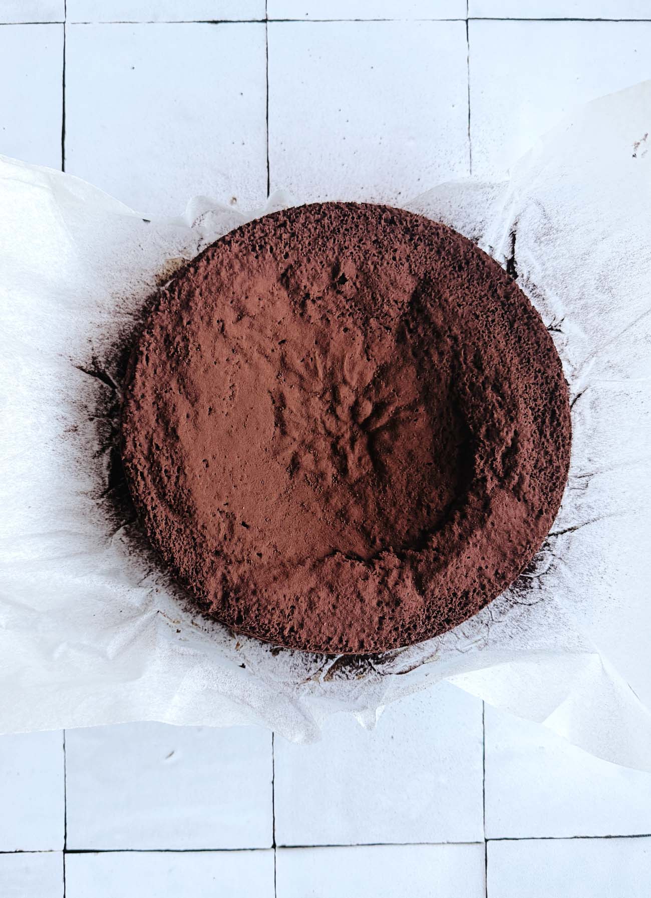 sunken chocolate cake on parchment paper