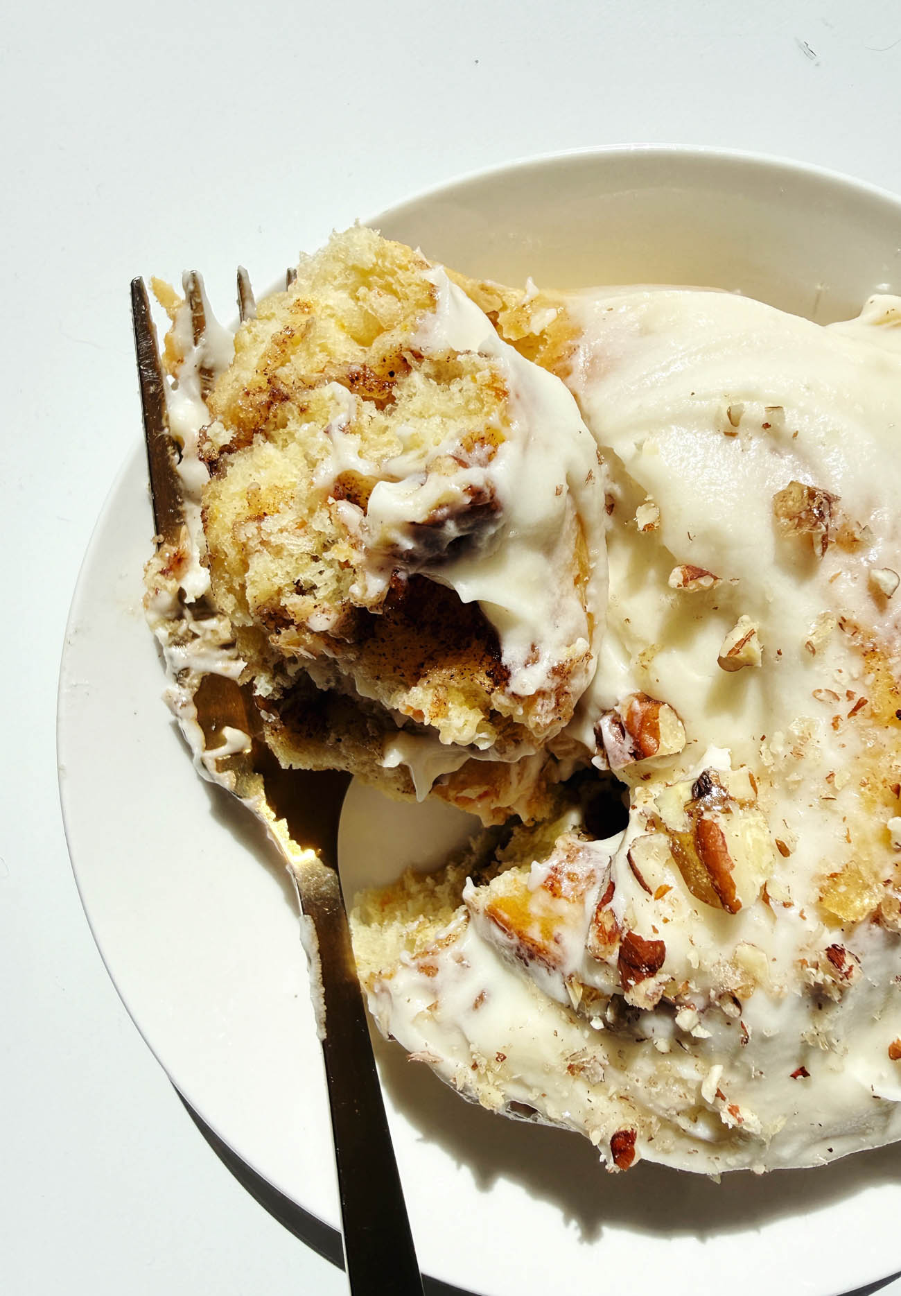 a bite out of carrot cake cinnamon roll