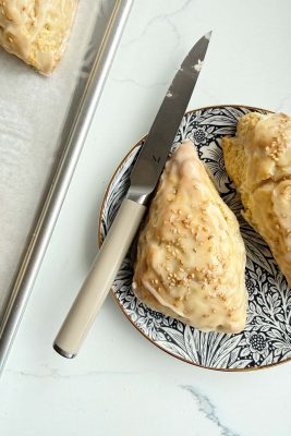 Delicious banana bread scones topped with toasted sesame icing, perfect for breakfast or tea.