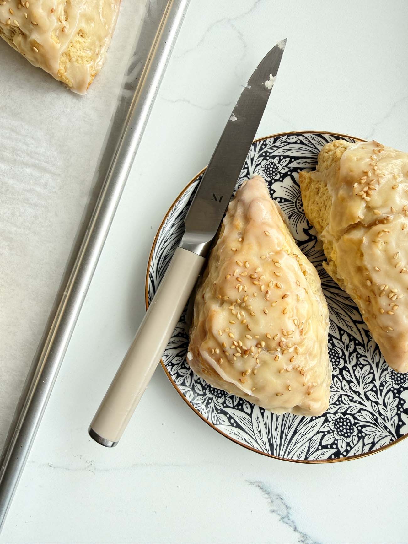 Delicious banana bread scones topped with toasted sesame icing, perfect for breakfast or tea.
