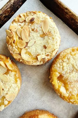 mini almond coffee cakes on a baking sheet