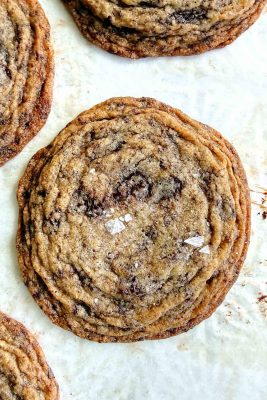 pan-banging chocolate chip cookies on parchment paper