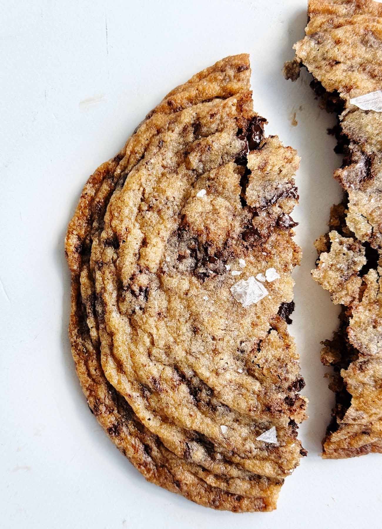 pan banging brown butter chocolate chip cookies on parchment paper