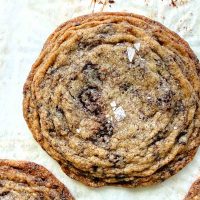 pan banging brown butter chocolate chip cookies on parchment paper