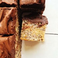 Close-up of banana bread bars topped with fudge buttercream frosting.