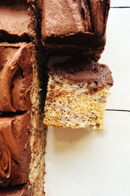 Close-up of banana bread bars topped with fudge buttercream frosting.